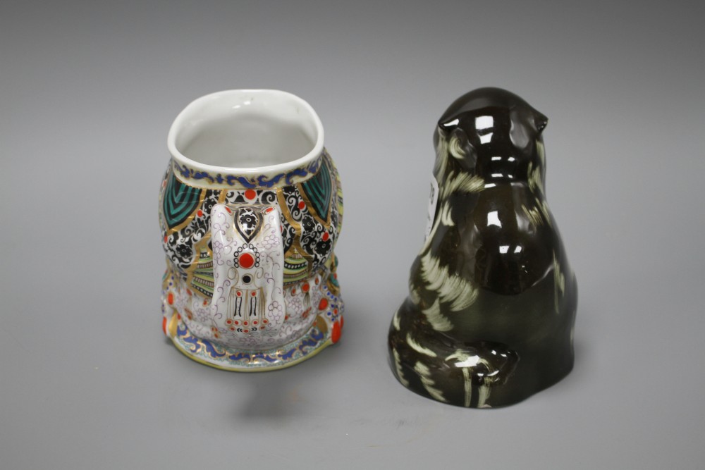 A Russian ceramic figure of a seated cat, height 15cm, and a character jug depicting a womans head with elaborate head-dress, height 1